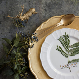 Holiday Gold place setting, napkin brown plaid, on grunge background